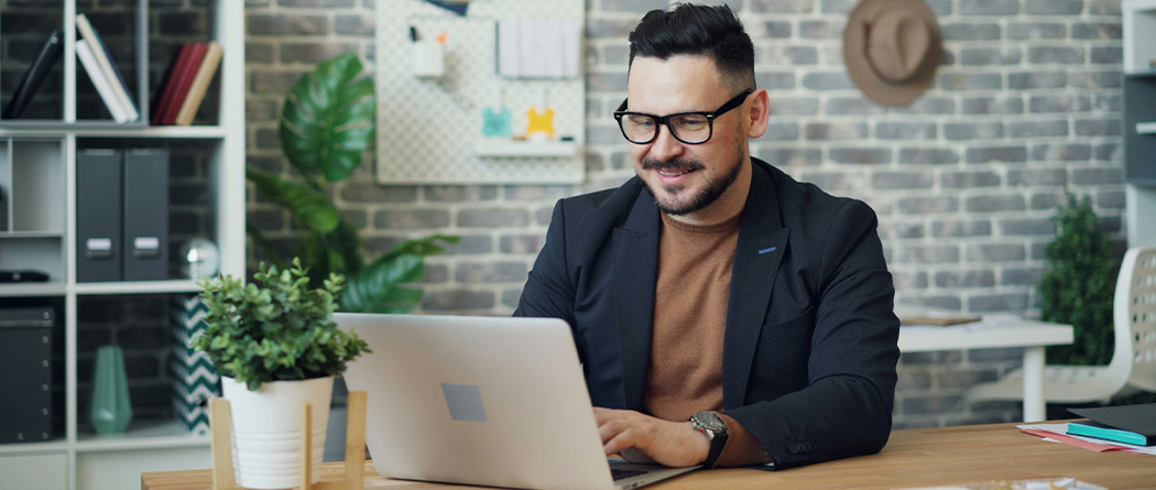 Professional Man using a computer sitting at a desk