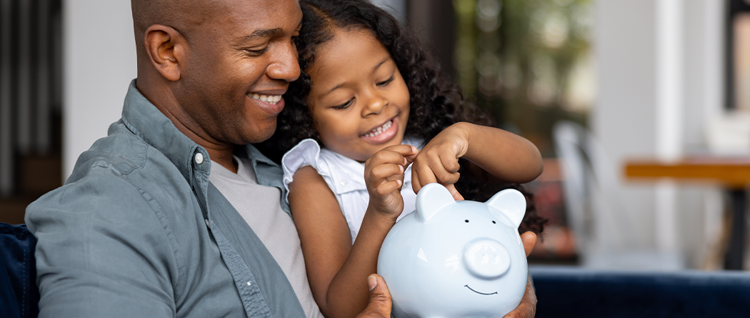 father and daughter learning about saving money
